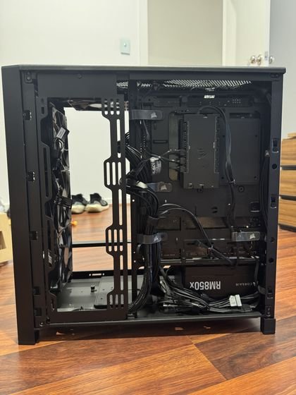 Open case during cable management, routed and tied behind the motherboard tray